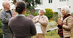 Meditation, coach and senior people outdoor with calm, peace and mindfulness in morning. Prayer hands, health club and group of elderly friends in backyard of retirement home for wellness on weekend.
