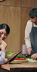 Cooking, tablet and family in kitchen at house for bonding, connection or preparing meal on weekend. Digital technology, happy and Asian mom and dad with child for cutting vegetables for diet dinner.