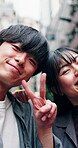 Face, laughing and peace sign with Asian couple in city for discovery or holiday exploration. Funny, hand gesture and vacation with tourist people in urban town for adventure, break or getaway