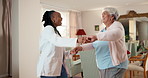 Happy, doctor and old woman dance in home for wellness, good news or recovery from medical condition. Flare, healthcare worker and senior person with celebration, healing and movement for fitness.