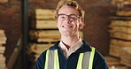 Happy, carpentry and man with face in workshop for joinery expertise, skilled craftsmen and pride. Glasses, carpenter and smile in warehouse for woodworking confidence, manual trade or manufacturing