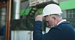 Logistics, man and outdoor by warehouse with helmet, operations manager thinking and plan shipping. Mature person, supervisor and reflection by factory with PPE, check supply chain and distribution.