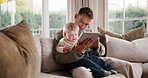 Tablet, relax and father with baby on sofa in home with educational game for cognitive development. Digital technology, people and dad with toddler in living room for online gaming, bonding or growth
