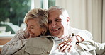 Support, smile and old couple on couch with hug, partner loyalty and bonding in connection. Love, bokeh and senior people in house with embrace, romantic moment and happy relationship in retirement.