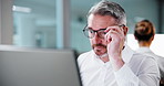 Computer, finance and glasses with business man in office for account or investment review. Reading, risk management and typing with mature employee at work on pc for financial feedback or report