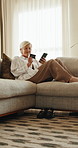 Relax, phone or mature woman with credit card for event ticket sale, reservation slot or fist pump. Fintech, person or excited on mobile banking in home for ticketing success, payment or celebration