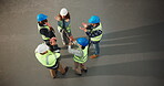 Top view, construction and team huddle with hands together for support, success or solidarity at job site. People, architect stack and excited renovation with applause, high five and unity with space