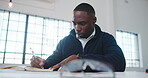 Architect, notebook or black man in agency with writing, design plan or draft of renovation project. Review, serious and engineer with notes, progress checklist and strategy brief for remodeling.