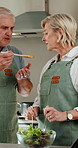 Cooking, support and old couple in kitchen with taste, happy moment and bonding with meal prep. Connection, food sampling and senior people with salad, healthy relationship and culinary hobby in home