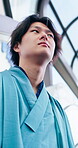 Culture, thinking and yakata with Asian man in city for commute, journey or traditional clothes. Escalator, ideas and travel with Japanese person outdoor in urban town for break, trip or vision
