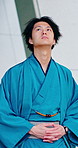Travel, city and Japanese man with traditional clothes, casual yukata and sightseeing on holiday. Person, walking and vacation in town for culture tourism with heritage, fashion and thinking outdoor