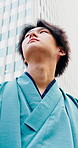 Buildings, thinking and yakata with Asian man in city for commute, journey or traditional clothes. Culture, travel and vision with Japanese person outdoor in urban town for break, inspiration or trip