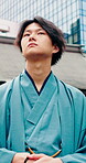 Buildings, thinking and yakata with Japanese man in city for commute, journey or traditional clothes. Culture, ideas and trip with Asian person outdoor in urban town for break, travel or vision