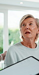 Physiotherapy, tablet and back of mature woman for consultation, online checklist and app. Physical therapy, patient and technology for chiropractic, writing and orthopedic wellness at clinic