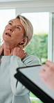 Physio, tablet and mature woman with neck pain at consultation, online checklist and app. Physical therapy, patient and technology for chiropractic, writing and orthopedic wellness at clinic