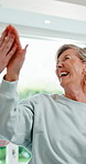Physiotherapy, high five and mature woman with exercise for rehabilitation, healing and fitness. Healthcare professional, patient and success with resistance band, laugh and stretching at clinic