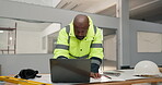 Black man, laptop and blueprint for construction in building, strategy and compare plans for renovation. Mature architect, technology or review digital floorplan with documents for engineering
