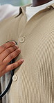 Doctor, hands and listening with patient heart beat in clinic for cardiology exam or medical checkup. Closeup, chest or healthcare worker monitoring breathing with stethoscope for health consultation