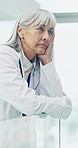 Doctor, thinking and woman in hospital with stress, overwhelmed and burnout for healthcare. Upset, lobby and mature person with reflection, worry and fatigue for medical crisis, career and mistake