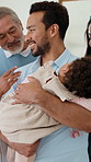 Grandparents, parents and sleeping baby in home with love, discussion or visit for bonding together. Happy, senior people and dad carry infant daughter in house with conversation, wellness or family.