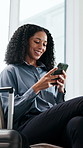 Phone, smile and business woman in airport lounge for networking event, global conference or convention. Trade show, online schedule and layover with person and travel suitcase in lobby for summit