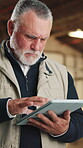 Planning, man and scroll on tablet for carpentry, cut list update and log client revision on app. Carpenter, mature person and tech in workshop for material specs, supplier website and lumber order