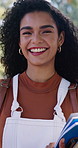 University, face or woman on campus with books, knowledge or scholarship in business course. Education, happy or college student with textbooks, confidence or academic growth in economics curriculum
