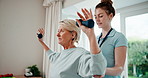 Physiotherapist, woman and help in clinic with dumbbells, rehabilitation and guide for arm exercise. Flare, mature person and physical therapist talk in office with weights, fitness advice or support
