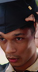Serious, graduation and man with cap at university for goal, education or academic achievement. Confident, ceremony and graduate student in mortarboard with pride for college milestone at campus.