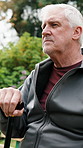 Senior, man and thinking with cane on park bench for outdoor walk, break or fresh air in nature. Thoughtful, elderly or male person contemplating with stick for mobility, health or wellness in garden