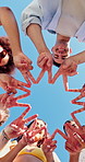 Fingers, below and face of people with star outdoor for unity, support or bonding at university. Happy, blue sky and portrait of students with hand shape for college solidarity, link or connection.
