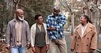 Family, walking and senior outdoor for bonding, relationship and trip in town with happy talking. Black people, mature parents and adult offspring on sidewalk, funny conversation and travel together
