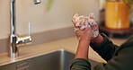 Kid, soap and washing hands by kitchen sink in home for hygiene, wellness and bacteria prevention. Child, antibacterial and tap in house for skincare, health and disinfection for cleaning with foam