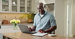 Laptop, home and black man with finance for expenses, budget planning or mortgage bills in kitchen. Male person, documents or checking invoice with computer for financial assessment or tax in house