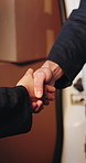 Shipping, team and shaking hands for delivery, success and distribution with vehicle or partnership. Logistics, achievement and people with boxes, handshake and deal with supplier and collaboration