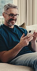 Laughing, phone or man on sofa with connection, online communication or comic post on social media. Happy, digital and mature person in home with browse, funny text and meme reaction on chat app.