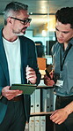 Finance, meeting and tablet with business men in office together for discussion at night. App, investment planning and teamwork with employee people in financial workplace for review of stock market