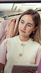 Woman, tablet and fashion in small business for retail, inventory and update online catalogue. Entrepreneur, smile and tech in boutique for stock management, logistics and check clothes on rail