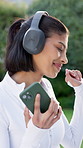 Fitness, dance and woman with phone for music outdoor, energy and streaming service with song. Runner, headphones and happy person with mobile at backyard, rhythm and radio for motivation playlist
