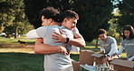 Charity, hug and smile of volunteer men in park for community service, outreach or greeting. Donation, food drive and teamwork with friends with handshake for ngo or non profit mission together