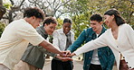 Park, friends and college student with hands together for applause, solidarity and celebration. Nature, huddle and happy people with clapping for higher education, admission or acceptance success