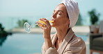 Pool, drink and woman at hotel for vacation, holiday and weekend getaway for me time or break. Hospitality, towel and person with mimosa, juice or cocktail for relax, travel and tourism at resort