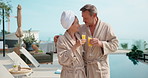Hug, drink and couple by pool at hotel for vacation, holiday and bonding on weekend getaway. Marriage, embrace and man with woman cheers with mimosa, alcohol and juice for love on break and travel