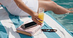 Person, hands and vacation with drink in swimming pool for holiday getaway or summer break. Travel, accommodation and relax by poolside with juice for luxury weekend or hospitality in spa or resort