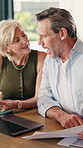 Laptop, documents and couple for finance, planning investment or asset management in home. Mature man, woman or discussion with computer or paperwork for financial audit, bills or expenses in house