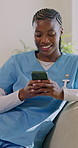 Nurse, woman and phone on sofa with laugh, funny text message notification and social media on break. Happy, black person and caregiver in nursing home with tech, meme and typing for online chat.