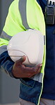 Construction, hands or hardhat on site for safety, protection gear or equipment in building project. Compliance, man or helmet for risk control, uniform or hazard prevention in industrial industry.