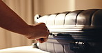 Person, hands and suitcase in bedroom for holiday getaway, weekend vacation or packing in hotel. Travel, luggage and zip with equipment, cargo or checking in for accommodation or hospital in resort