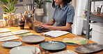 Pottery, typing and woman with laptop, website and sale review for inventory management at store. Studio, startup and person on computer for online order, report or stock for designer ceramic product
