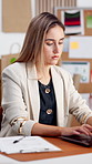 Woman, typing and laptop at startup for ecommerce, pricing and stock availability for shipping. Entrepreneur, reading and tech in workplace with clipboard, supply chain and online order for delivery